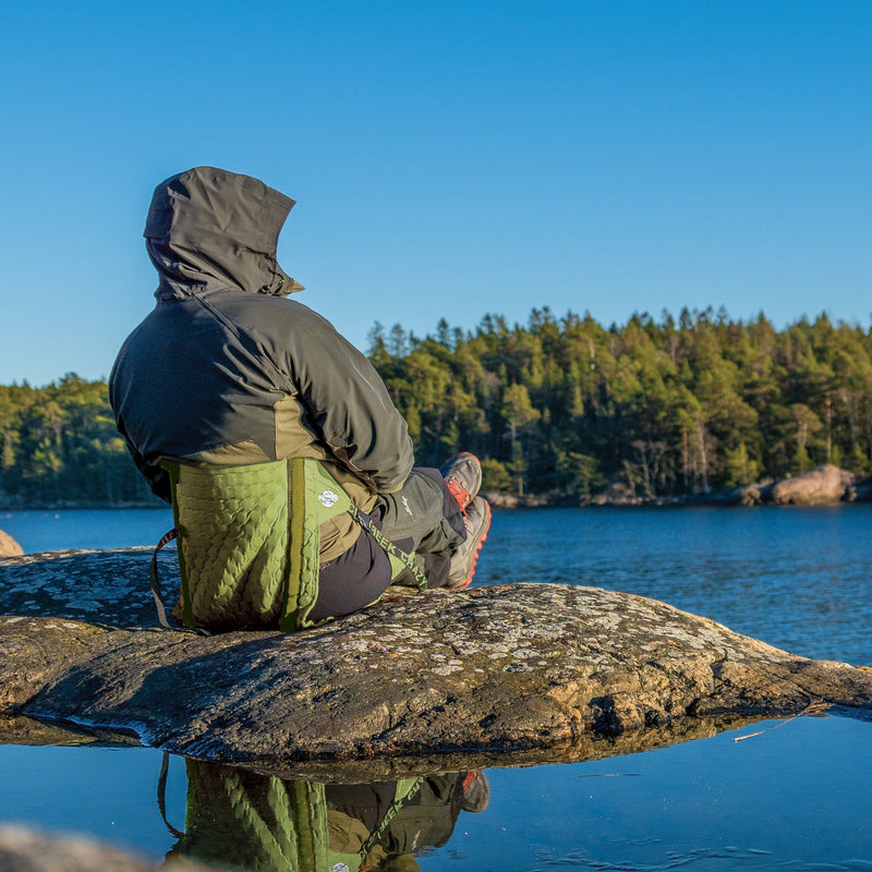 Load image into Gallery viewer, Man sitting in front of a lake in his olive green hex 2.0 chair