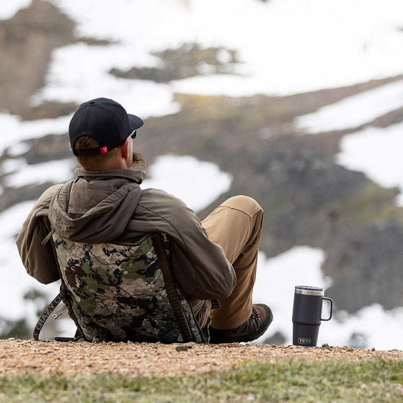 Load image into Gallery viewer, Man sitting in a camo chair relaxing in snowy mountains