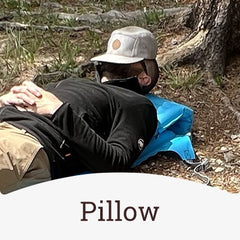 The air chair being used as a pillow by a man on the ground