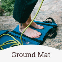 Crazy Creek chair being used as a ground mat for a rockclimber