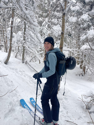 Woman backcountry skiing in the snowy mountains