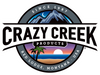 Crazy Creek Products logo featuring a mountain and beach-themed design, representing outdoor adventure and comfort.