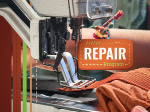 Sewing machine with a piece of fabric on a Crazy Creek chair and a 'Repair Program' label - send in your old gear to be fixed